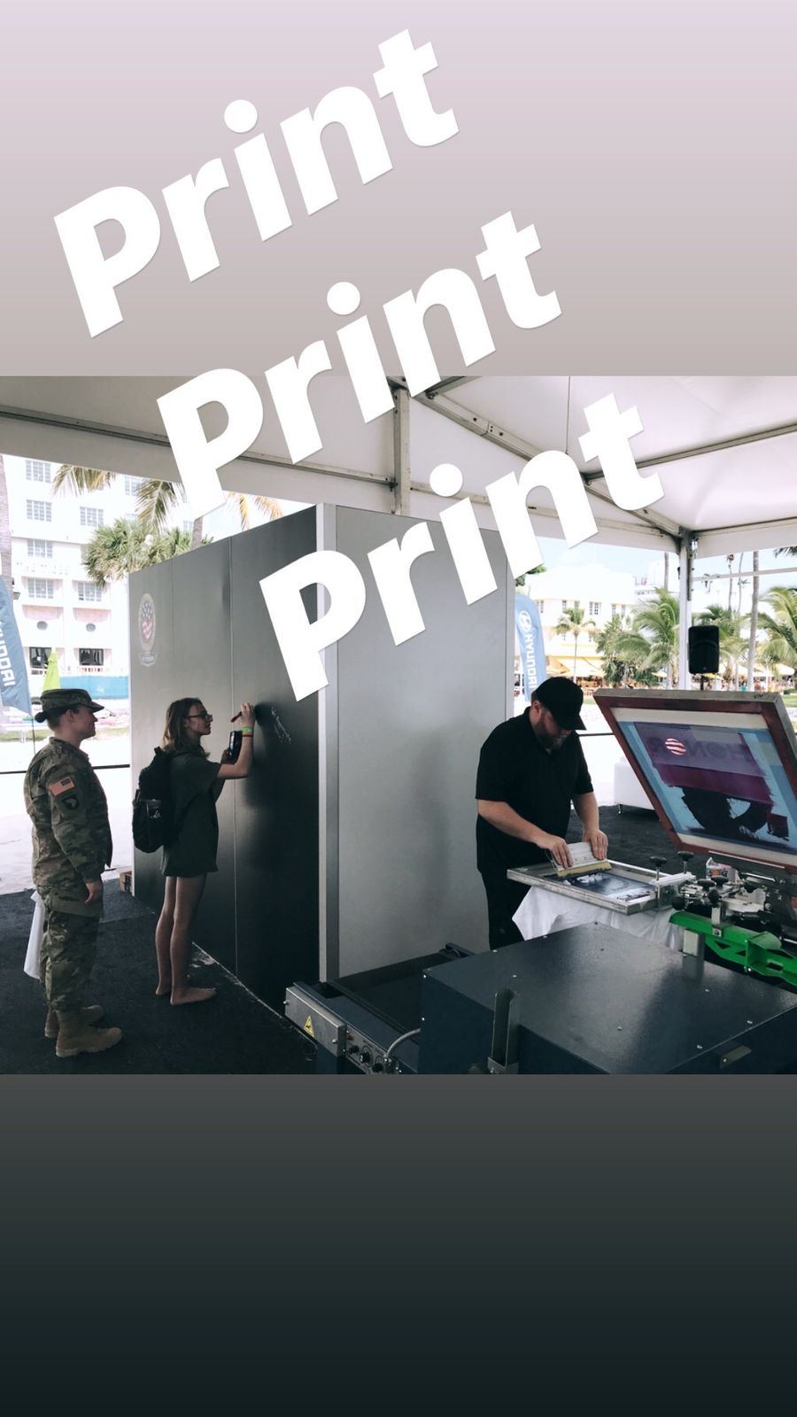 Guests watching custom merch get printed live at a Sacramento event